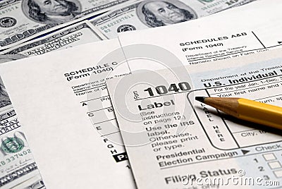 Tax Forms on top of Money Editorial Stock Photo