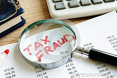 Tax fraud written on the audit report. Stock Photo