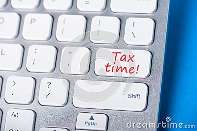 Tax time - Key on keyboard - Notification of the need to file tax returns, message for accountant - fill in tax form Stock Photo