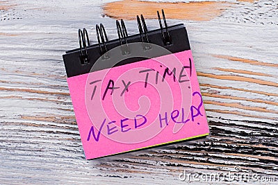 Tax time message on a paper of mini notepad. Stock Photo