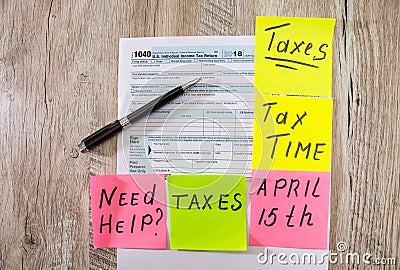 Tax time on a sticker with a pen on a tax form. Financial document. View from above. 1040 tax form. Editorial Stock Photo