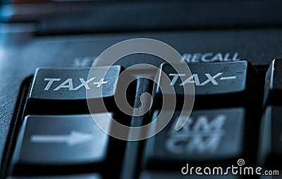 Tax word on used calculator, conceptual image of increasing taxes Stock Photo