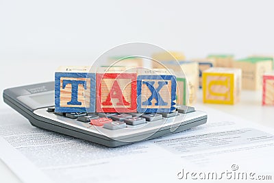 Taxation concept with wooden cubes and calculator Stock Photo