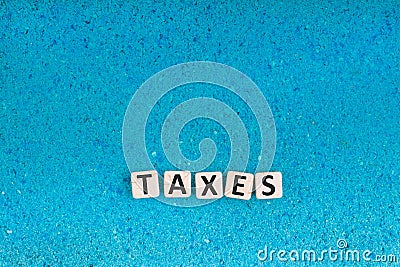 Taxes word on stone Stock Photo