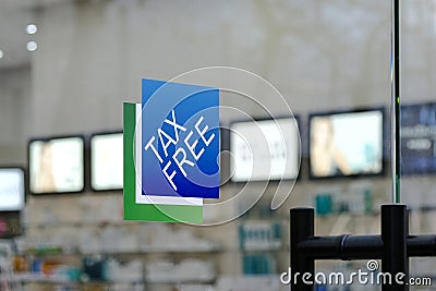 Taxfree logo sign on the glass door background of a store with goods Editorial Stock Photo