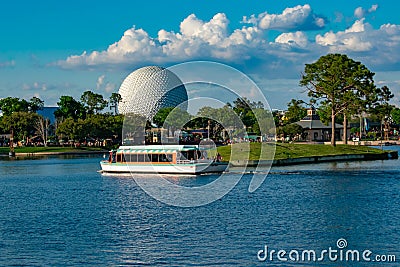 Taxi boat sailing and panoramic view of sphere Spaceship Earth attraction at Epcot in Walt Disney World . Editorial Stock Photo