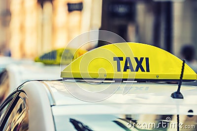 Taxi car waiting passengers in town.Taxi light on the cab of the car ready to transport the passengers Stock Photo