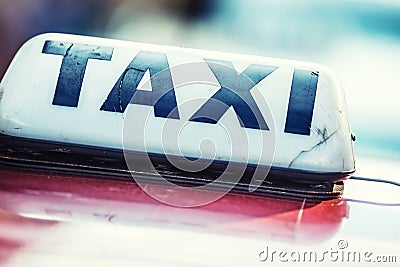 Taxi car waiting passengers in town.Taxi light on the cab of the car ready to transport the passengers Stock Photo