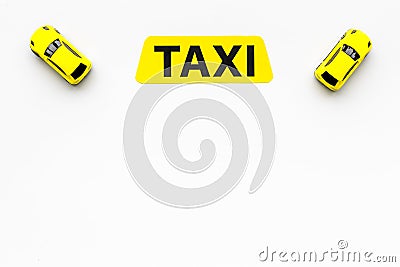 Taxi concept. Yellow service sign text taxi near car toy on white background top view space for text Stock Photo