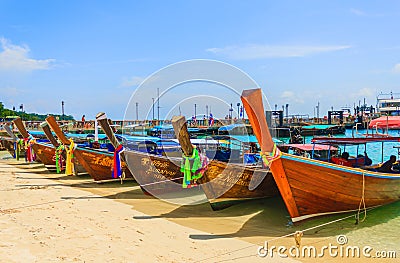 Taxi long-tail boats wait for tourists on beach, sunny day Editorial Stock Photo