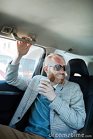 Taxi passenger drinking coffee Stock Photo