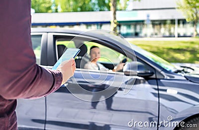 Taxi phone app for cab or car ride share service. Customer waiting driver to pick up on city street. Man holding smartphone. Stock Photo