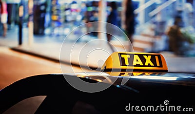 Taxi sign on the roof of a car Stock Photo