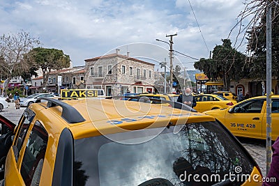Seferihisar, Izmir, Turkey - 03.09.2021: Turkish Taxicab stand and a lot of waiting taxi cars and a costumer with mask waiting Editorial Stock Photo