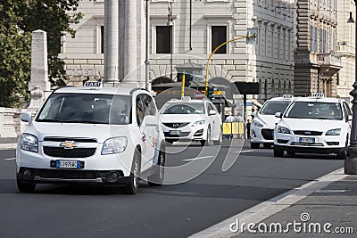 White taxi traffic in the historic center of Rome Editorial Stock Photo