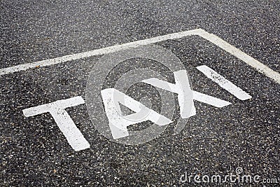 Taxi word painted on tarmac Stock Photo