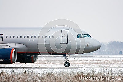 Taxiing aircraft in a winter airport Stock Photo