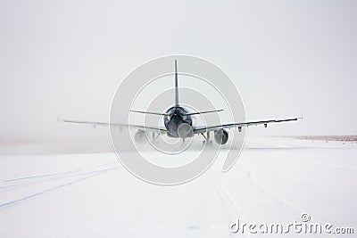 Taxiing passenger aircraft in a snow blizzard Stock Photo