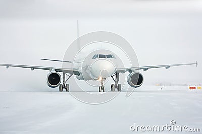 Taxiing passenger airplane in a snow blizzard Stock Photo