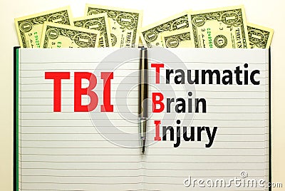 TBI traumatic brain injury symbol. Concept words TBI traumatic brain injury on white note on a beautiful background from dollar Stock Photo