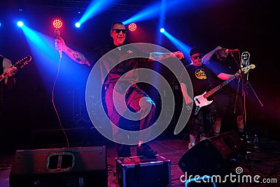 TBILISI, GEORGIA - OCTOBER 23, 2022: Male vocalist, singer holds a microphone and sings a song on stage. Musical performance, rock Editorial Stock Photo