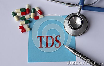 TDS - medical abbreviation on a blue sheet on the background of tablets, stethoscope and pen Stock Photo