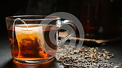 Tea bag in a hot tea cup on a table Stock Photo