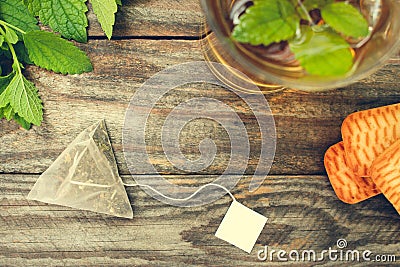 Tea bag, mint, cookie and cup of tea. Stock Photo