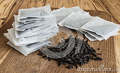 Tea bags and loose tea on a wooden board Stock Photo