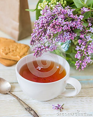 Tea and blooming lilac, petal in a cup Stock Photo