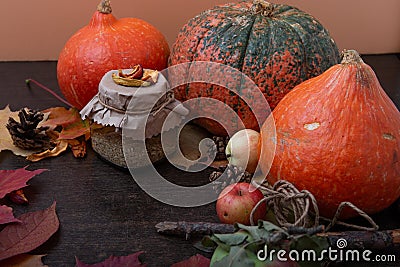 Tea can, autumn fruits and vegetables on a brown wooden table, dry fruits, apples, pumpkins, autumn mood Stock Photo