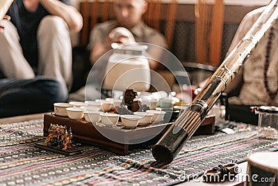 The tea ceremony is conducted by a tea master. tea party in the style of boho, hippie. tea cups on a special wooden Stock Photo