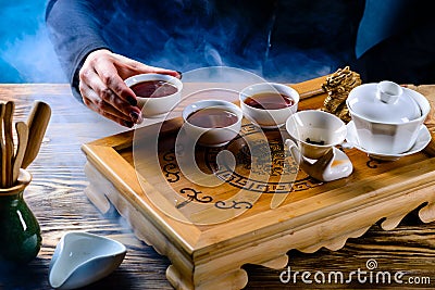 tea ceremony, the girl pours tea puer in bowls Stock Photo