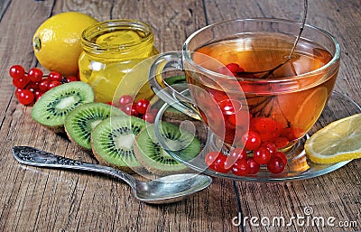 Tea for cold and flu. Lemon, ginger, kiwi fruit, and viburnum for tea for a cold. Stock Photo