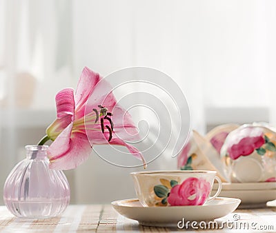 The tea cup is decorated with nicely pink flowers. Stock Photo