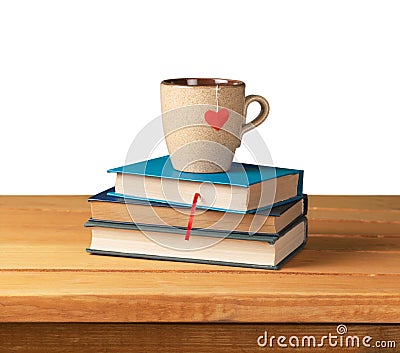 Hardcover books and cup with heart shape on wooden Stock Photo