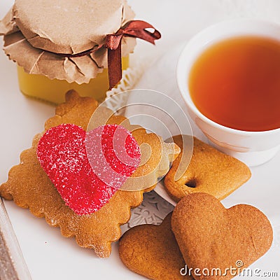 Tea cup with heart shaped biscuits. Sugar red biscuits. A square, equal sides. Instaphoto with filters Stock Photo