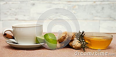 Tea cup, raw ginger, lime and honey Stock Photo