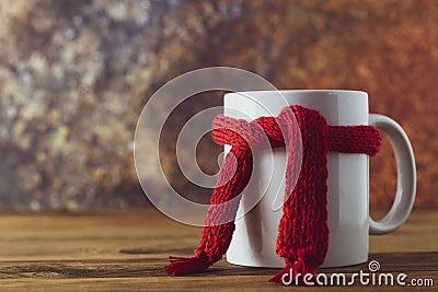 Tea cup of tea with red warm knitted scarf. Autumn, fall background. Cold and illnes season Stock Photo