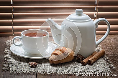 Tea cup with teapot on old wooden table Stock Photo