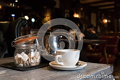 Tea cup, Teapot and sugar lumps in jar Stock Photo