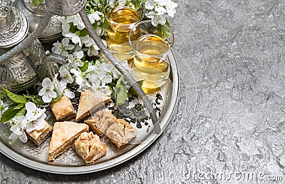 Tea cups and pot. Oriental silver tableware. Flowers decoration Stock Photo