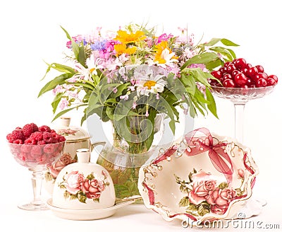 tea in elegant cups, raspberry and flowers Stock Photo
