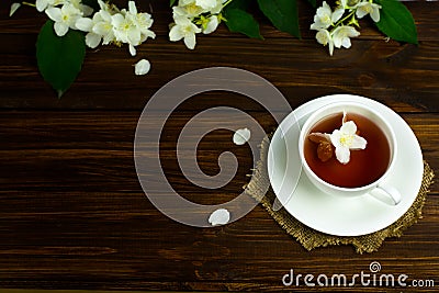 Tea with jasmine in a white mug on a wooden table Stock Photo