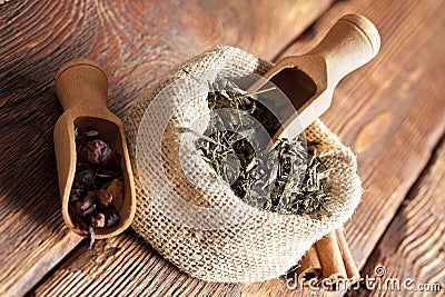 Tea leaves in linen bag on wooden planks Stock Photo