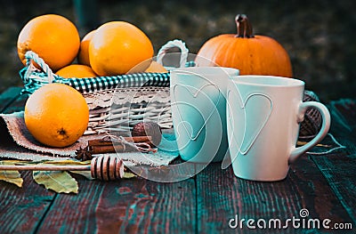 tea with lemon, honey, oranges, autumn leaves on woodenbackground Stock Photo