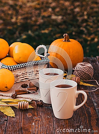 tea with lemon, honey, oranges, autumn leaves on woodenbackground Stock Photo