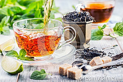 Tea. Mint Tea. Herbal tea. Mint leaf. Mint leaves. Tea in a glass cup, mint leaves, dried tea, sliced lime. herbs tea and mint lea Stock Photo