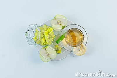 Tea in a mug with apple, dried fruit, sugar cubes, candy flat lay on a white background Stock Photo