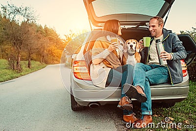 Tea party in car truck - loving couple with dog sits in car truck Stock Photo